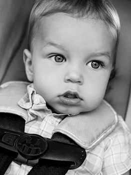 Young child secured in a car seat.