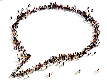 Aerial view of large group of people forming a speech bubble