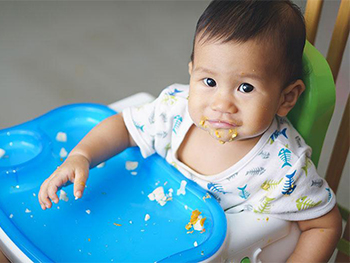 Baby sitting in a highchair 