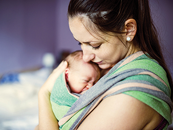 Newborn being held by mother