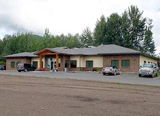 Chetwynd Clinic with 3 vehicles parked out front.