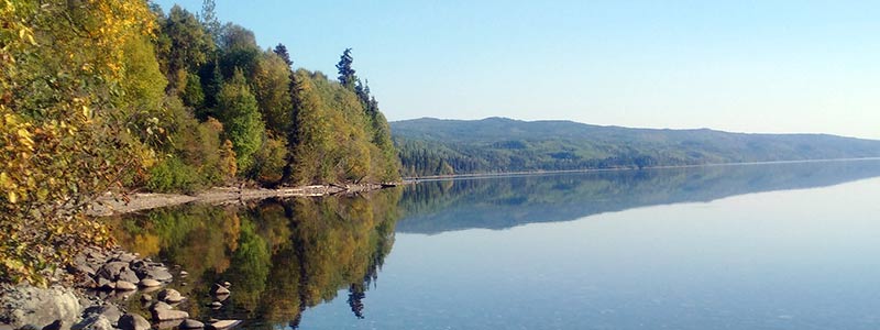 Lake in early fall with leaves changing colours.