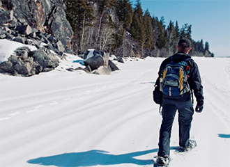 Person snowshoeing up a mountain slope