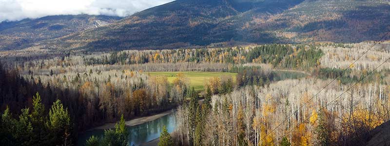 Valley view of a river and mountains in the fall.