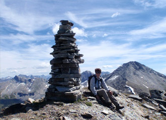 Person at the top of a mountain after a climb.