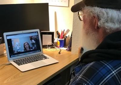 Senior using his laptop to attend a telehealth appointment.