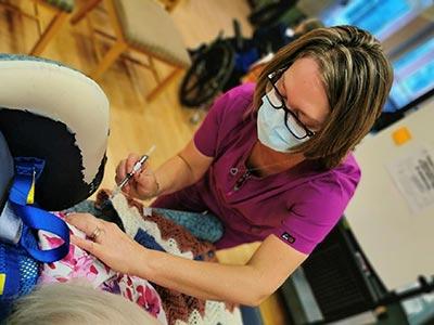 Vaccination being given by a medical professional wearing a mask